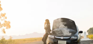 car accident. woman on phone calling insurance.