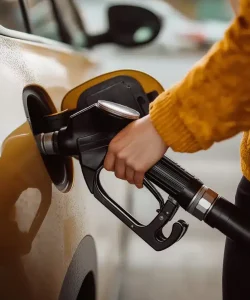 close up, girl at the gas station filling her car